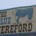 Blue Hereford Diner Road Sign in Ford Kansas (cropped)