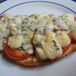 Toasted Bread Topped with Sliced Tomatoes and Broiled Blue Cheese