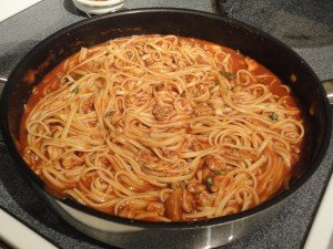 Linguine with Red Clam Sauce Finishing Off in a Skillet