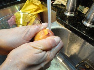 Skin Being Removed from a Frozen Peach