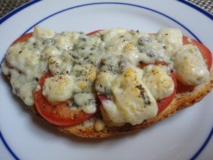 Toasted Bread Topped with Sliced Tomatoes and Broiled Blue Cheese