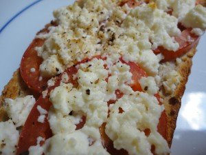 Toasted Bread Topped with Sliced Tomatoes and Broiled Feta Cheese