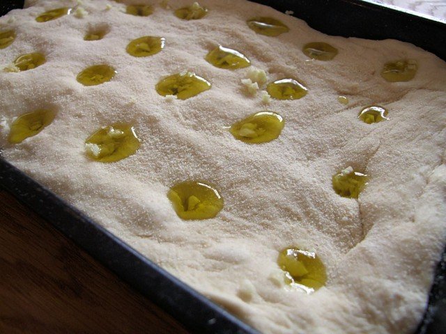 Olive oil poured into the holes in the Focaccia