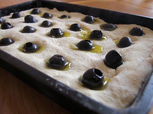 Olives placed into the Focaccia